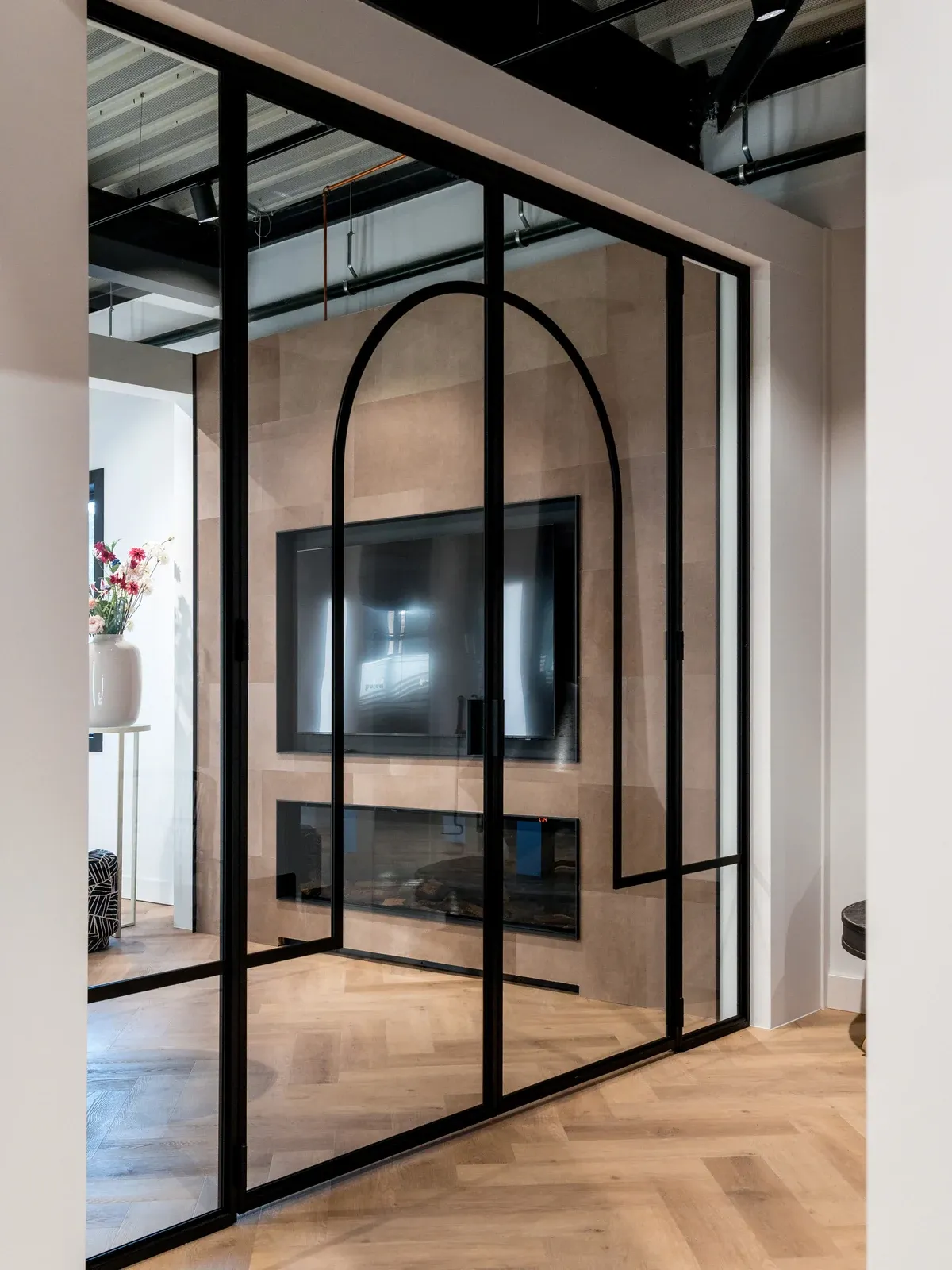 Schwarze Drehtür mit maßgefertigtem Sprossendesign.