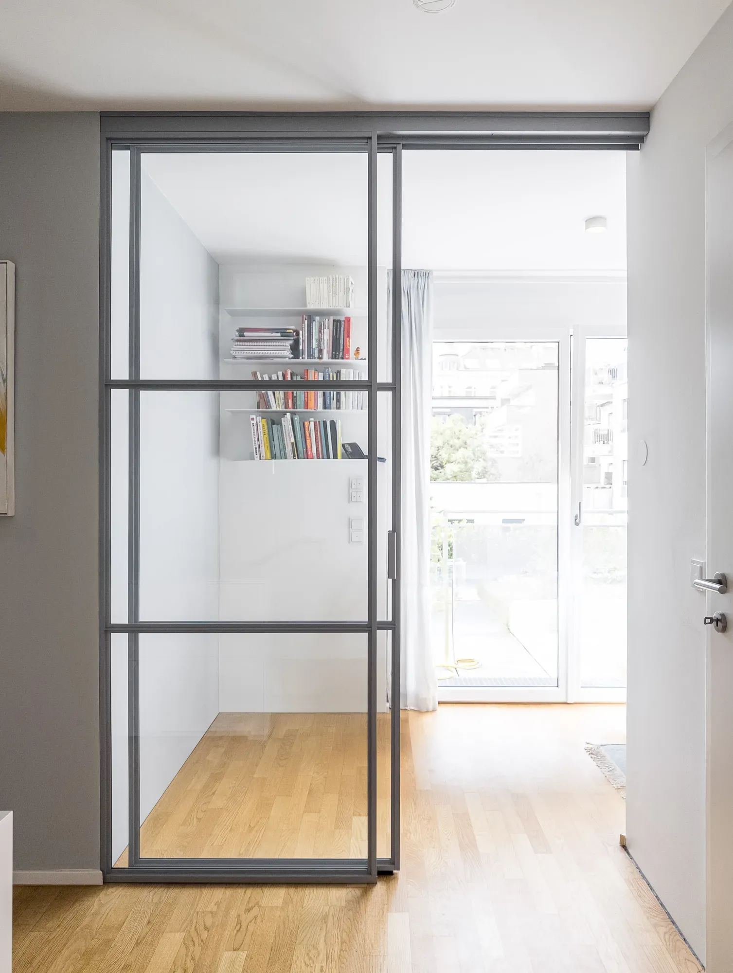 Geschlossene Schiebetür in Fenstergrau mit zwei horizontalen T-Profil-Sprossen zum Home-Office